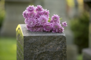 Pink flowers on grave stone