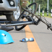 Bicycle knocked down by vehicle with helmet on road