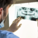 Dentist looking at dental x-ray