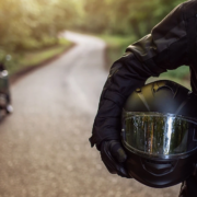 Rider holding motorcycle helmet